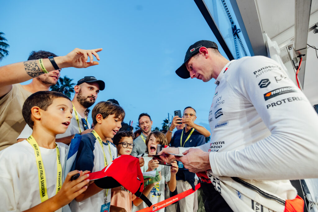 Toyota Gazoo Racing WRC driver Elfyn Evans signs autographs for young fans at Rally Italia Sardegna.