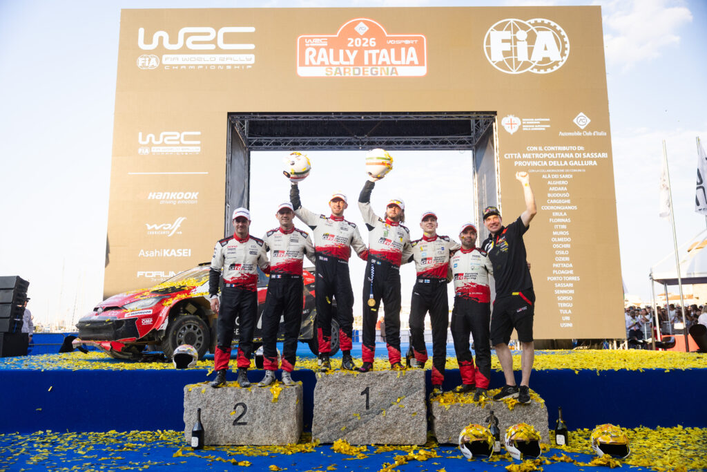 Toyota Gazoo Racing drivers celebrate on the podium at the WRC Rally Italia Sardegna.